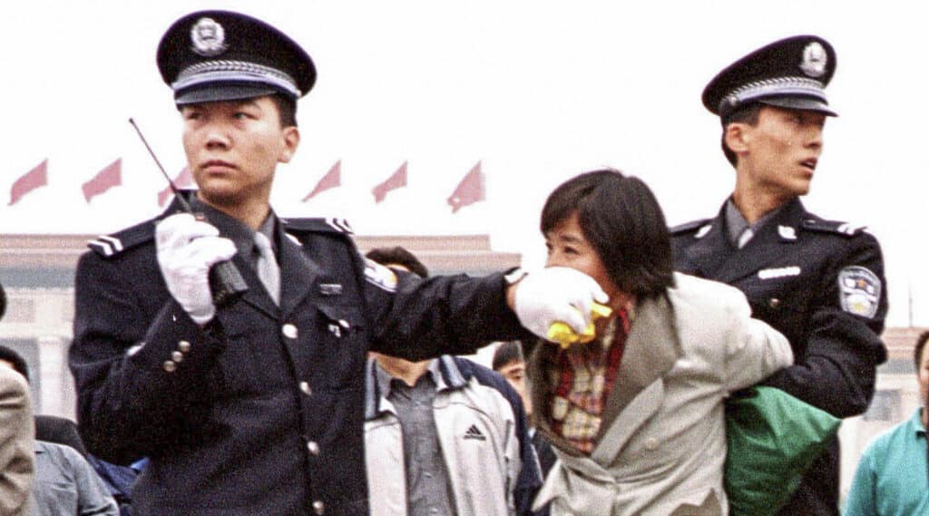 Chinese police detain a Falun Gong practitioner on Tiananmen Square